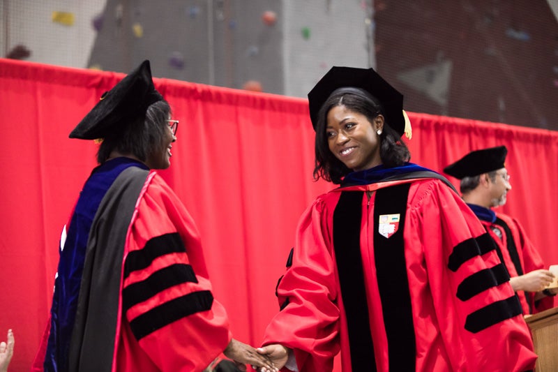 Photo of a graduate walking across the stage