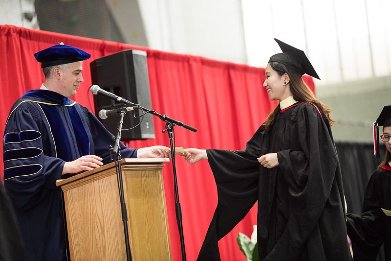 Photo of graduates walking across the stage