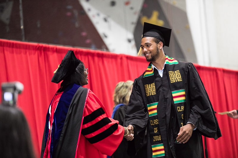 Photo of graduate walking across the stage