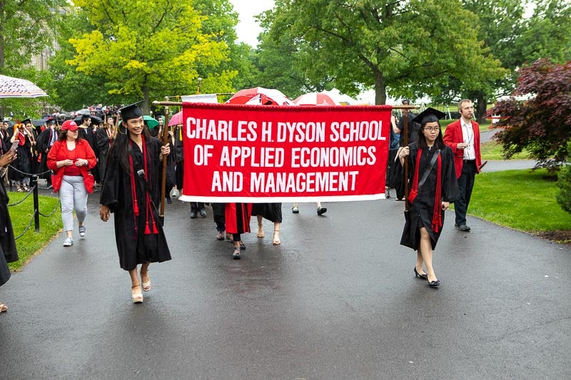 Photo of graduates carrying the Dyson banner