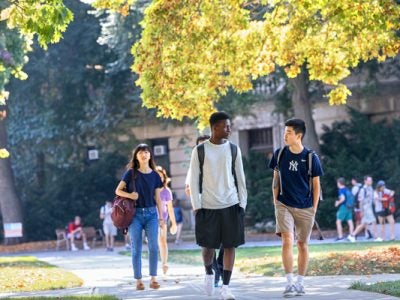 Photo of students walking and talking on the quad