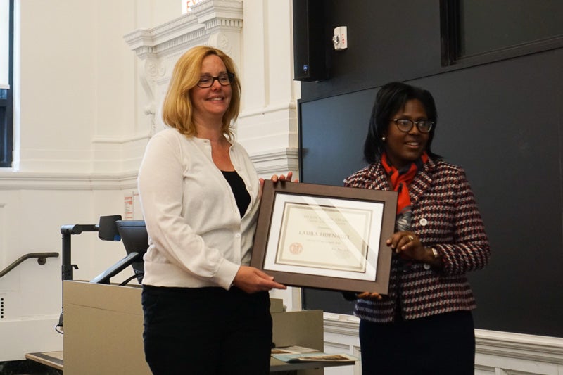 Photo of Laura holding a certificate
