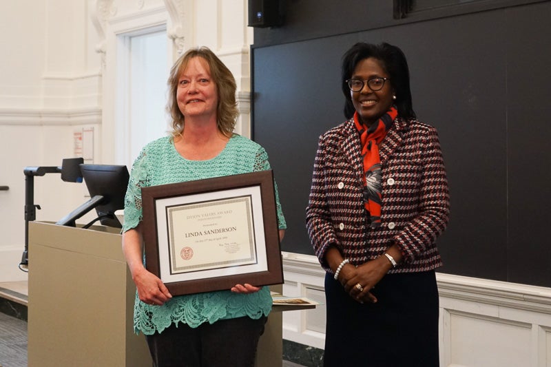 Photo of Linda holding a certificate
