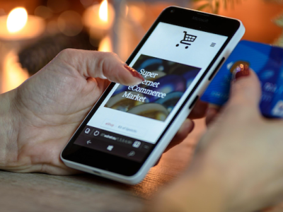 Close up of a person holding a phone that says ecommerce