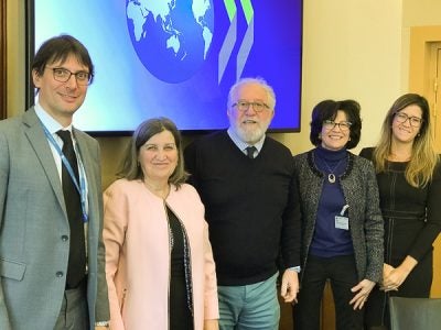 People stand in front of a presentation