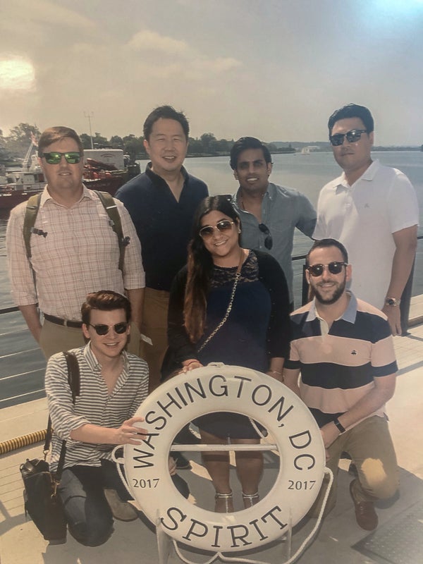 A group poses with a life saver that says Washington, DC Spirit