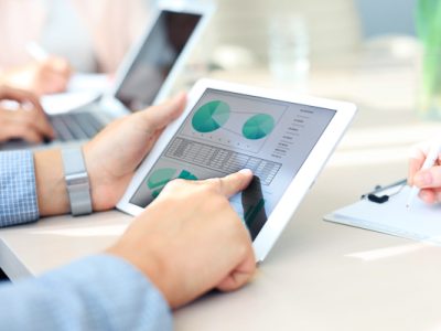 Business person analyzing financial statistics displayed on the tablet screen
