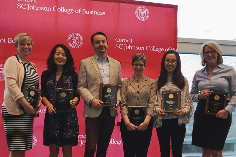 Photo of faculty holding certificates