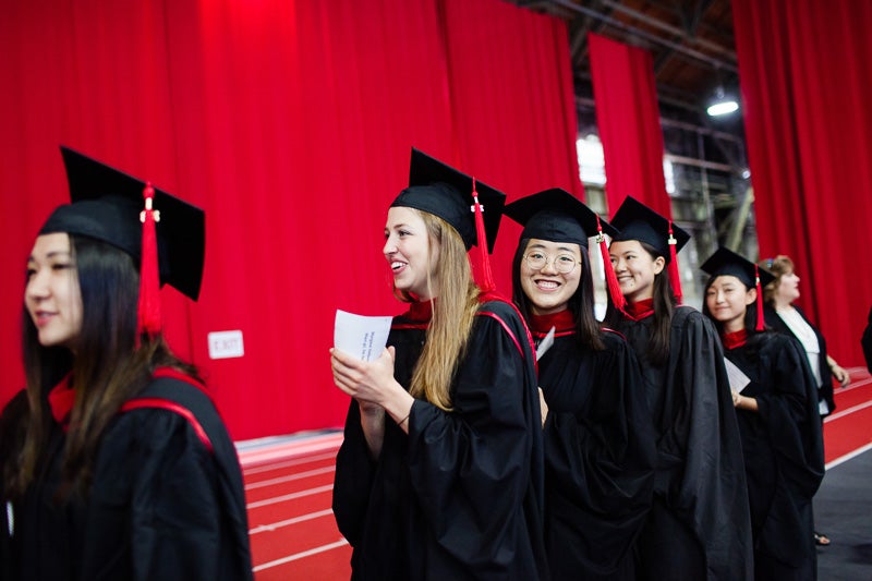 Photo of graduates walking to get their degrees