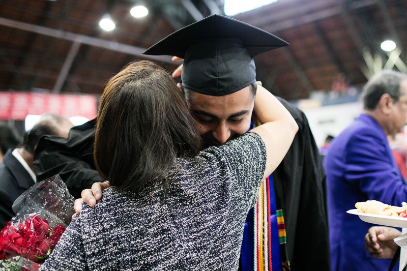 Photo of a graduate hugging a woman