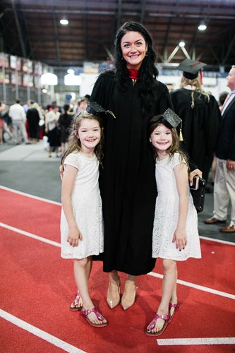 Photo of a graduate with two young girls