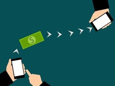 illustration of two mobile phones connected by arrows with a dollar bill between them.