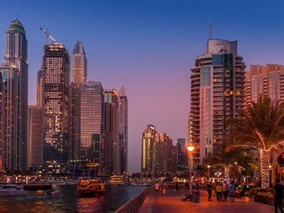 City buildings on either side of a main street in Dubai.