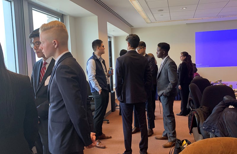 Students look out windows while networking