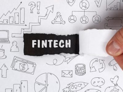 Photo of drawing and fintech terms with the paper being ripped to reveal "fintech"