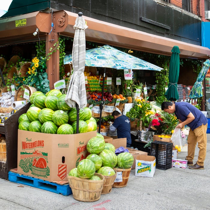Man buying lemons at a neighborhood market in NYC