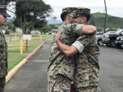 Edmund Fuentes in military uniform hugging another solider