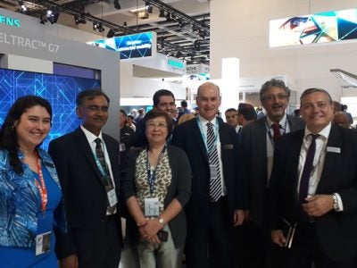 Group of people standing in a trade show booth