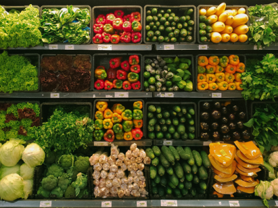 rows of vegetables in a grocery store cooler