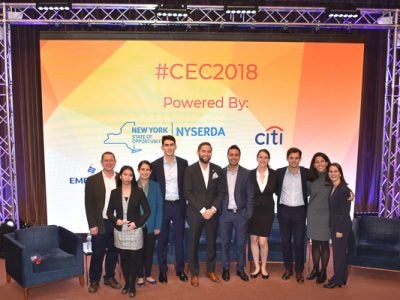 A group poses on the stage at the Cornell Energy Connection