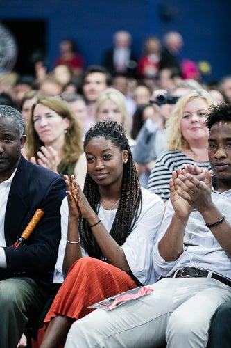 Photo of a family in the audience clapping