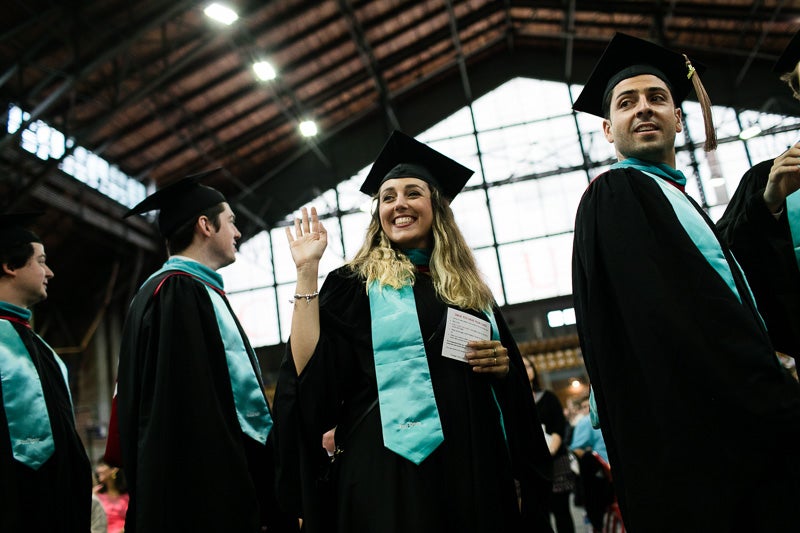 Photo of a graduate waving