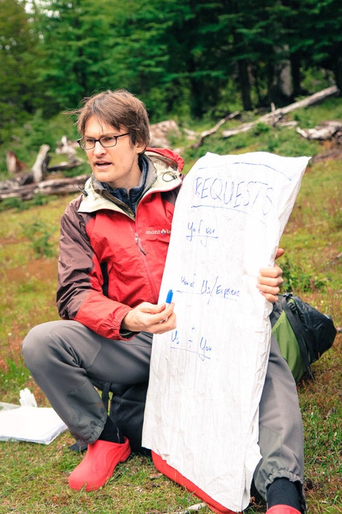 Jamie holding an easel and marker outdoors