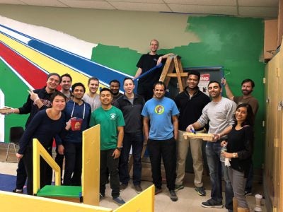 Photo of students painting a playroom