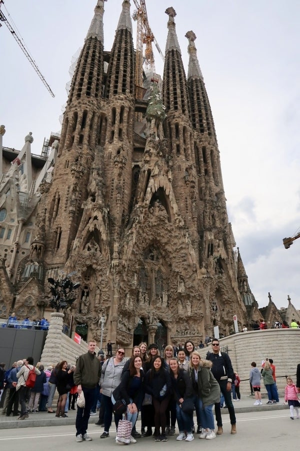 Students pose in front of church 