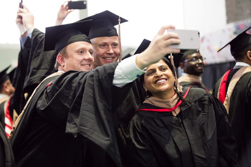 Photo of graduates taking selfies