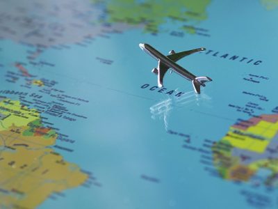 Photo of a plane flying across the Atlantic Ocean on a map