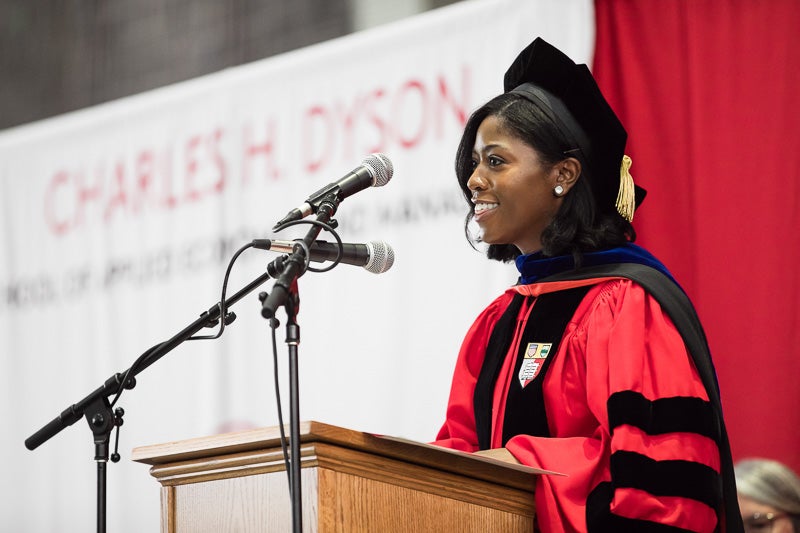 Photo of Jakina speaking at a podium