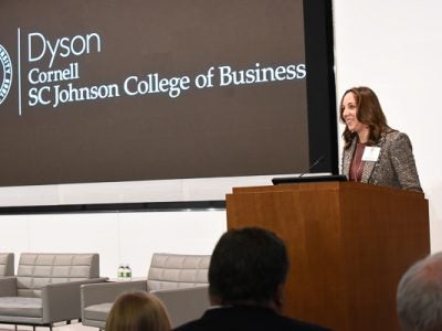 Jen Davis speaking at a podium