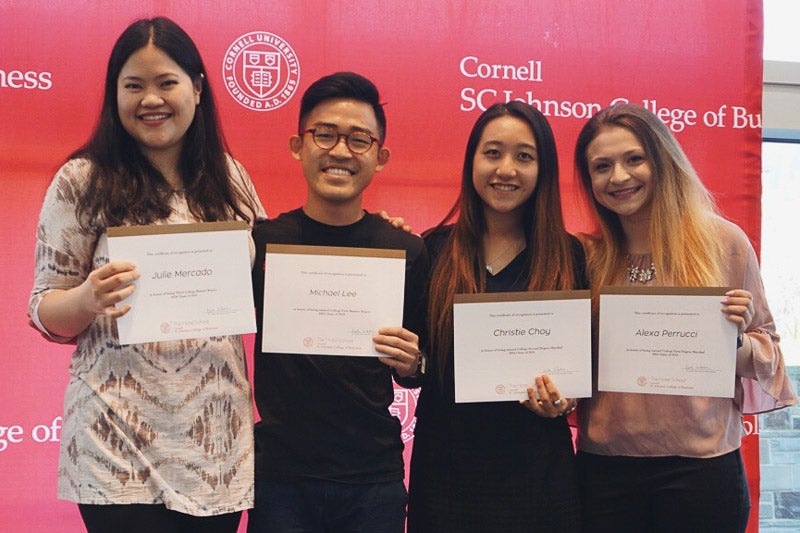 Photo of Julie, Michael, Christie, and Alexa standing with certificates
