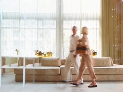 A man and a woman walk through the lobby of a hotel