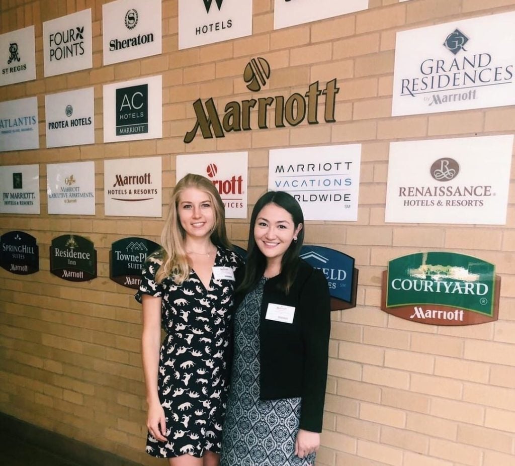 Alex and Karolina in front of Marriott brands signs