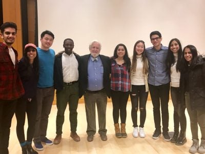 Photo of Karpman standing with a group of students