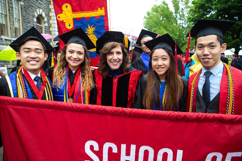 Photo of Kate and students carrying a banner