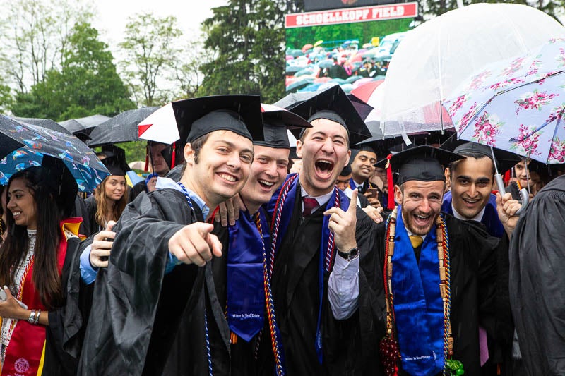 Photo of three graduates smiling
