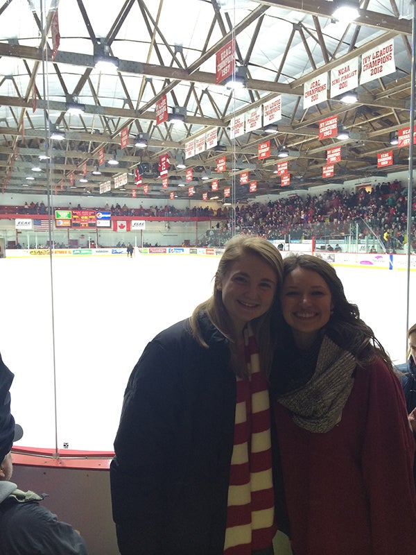 Photo of two students in front of the ice at the Cornell