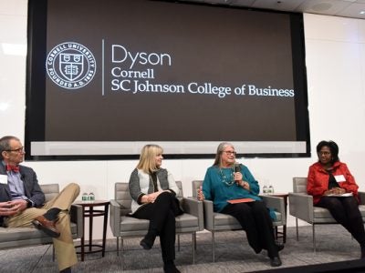 Ed, Deb, Dale, and Lynn sitting on stage in a panel