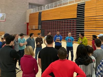 Students gather in a gymnasium