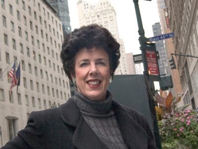 Photo of Lynne Allen sitting on a bench in NYC