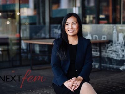 Portrait of Maggie Chan Jones with Nextfem logo