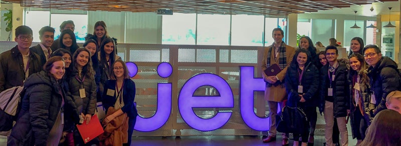 Large group standing around a jet sign