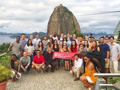 Photo of the MBA group standing at the top of a summit