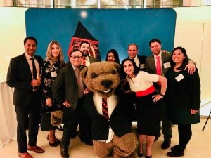 Photo of a group of people with Touchdown the bear at a reception