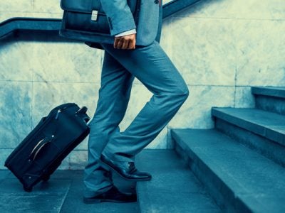 Walking up stairs with a suitcase