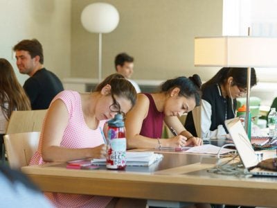 Photo of students studying with laptops
