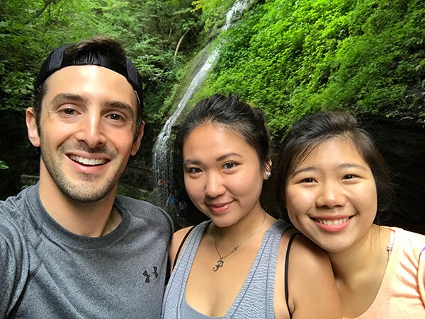 Photo of Nathan with two other students in front of one of Ithaca